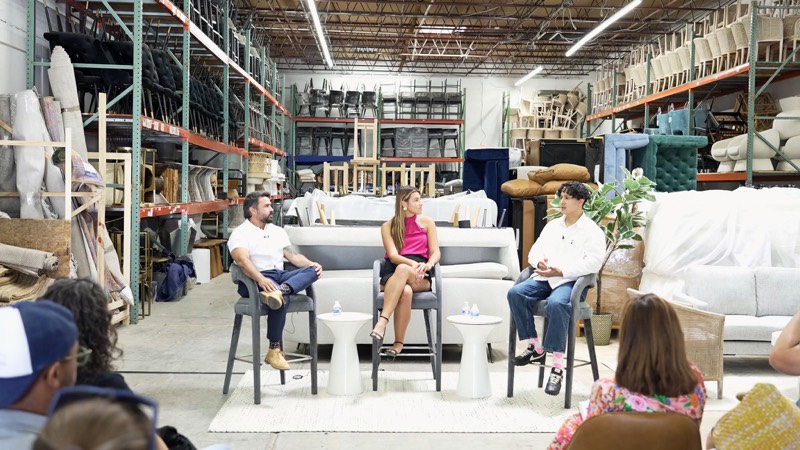 A panel on a furniture-showroom set, with an audience in front